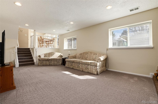 living room with carpet flooring and a textured ceiling