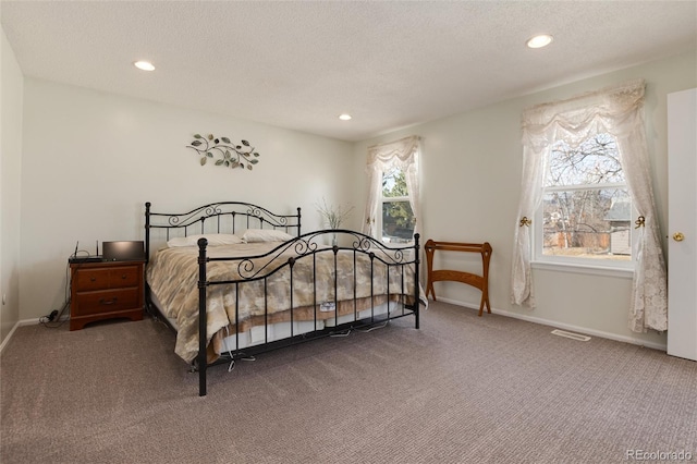 carpeted bedroom with a textured ceiling