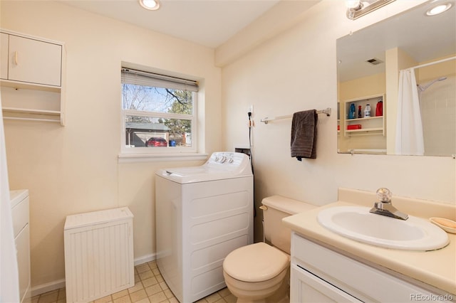 bathroom featuring washing machine and dryer, vanity, radiator, and toilet