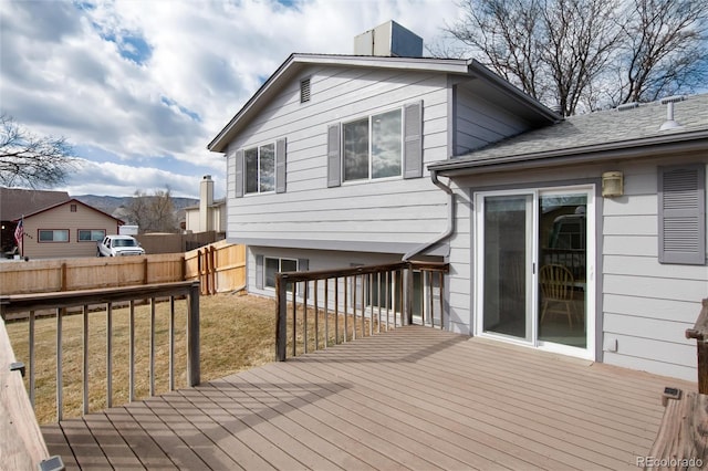 wooden deck featuring a lawn