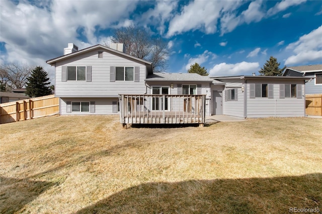 rear view of house with a yard and a deck