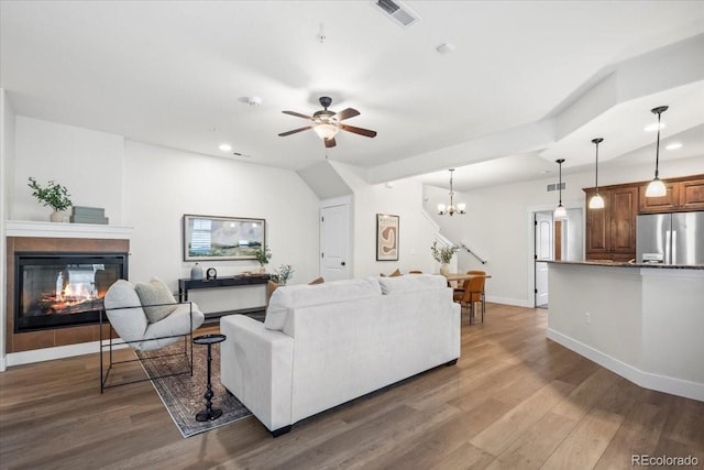 5850 Dripping Rock Ln Unit G102, Fort Collins, CO 80528 - living room with a multi sided fireplace, ceiling fan, wood finished floors, a chandelier, and recessed lighting