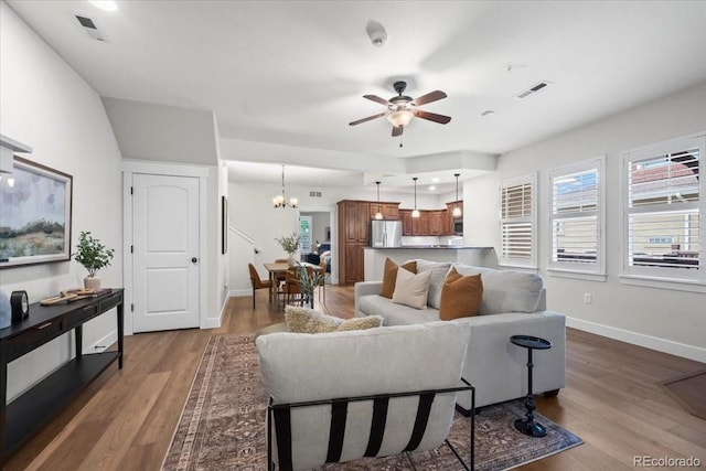 5850 Dripping Rock Ln Unit G102, Fort Collins, CO 80528 - living room featuring ceiling fan, wood finished floors, a chandelier, and baseboards