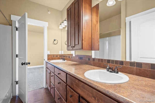 5850 Dripping Rock Ln Unit G102, Fort Collins, CO 80528 - bathroom featuring double vanity, tile patterned flooring, and baseboards