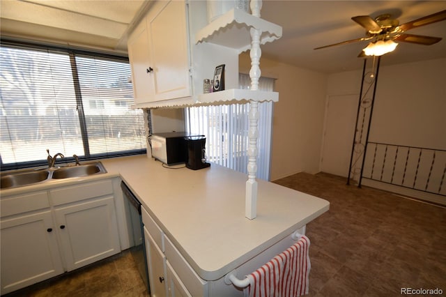 kitchen with white cabinetry, sink, and ceiling fan