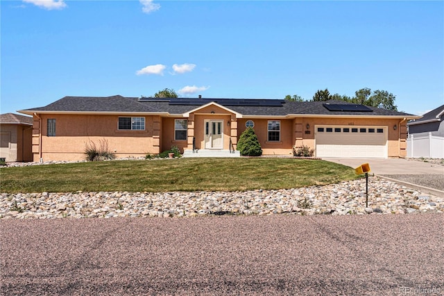 465 W Palmer Lake Dr, Pueblo, CO 81007 - ranch-style house featuring a garage, concrete driveway, stucco siding, and roof mounted solar panels