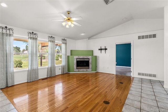 465 W Palmer Lake Dr, Pueblo, CO 81007 - unfurnished living room featuring vaulted ceiling, light wood-style floors, a fireplace, a ceiling fan, and baseboards