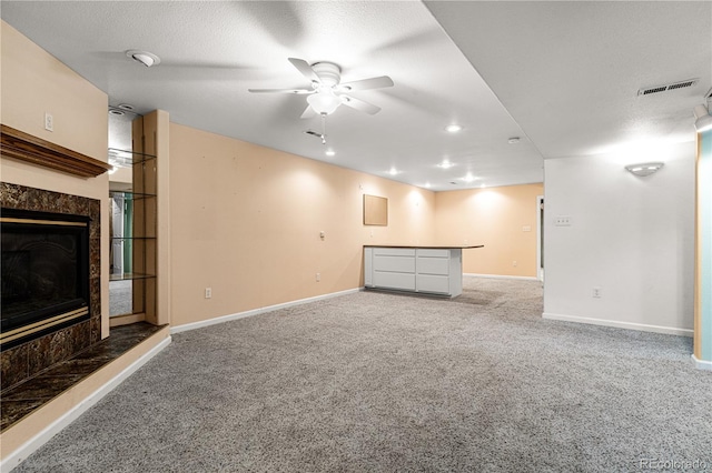 465 W Palmer Lake Dr, Pueblo, CO 81007 - unfurnished living room featuring a high end fireplace, light carpet, ceiling fan, baseboards, and recessed lighting