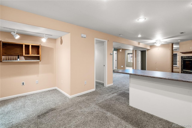 465 W Palmer Lake Dr, Pueblo, CO 81007 - basement with carpet floors, a tiled fireplace, a ceiling fan, and baseboards