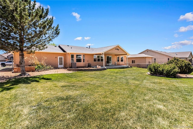 465 W Palmer Lake Dr, Pueblo, CO 81007 - rear view of property with a patio, a yard, stucco siding, and central AC