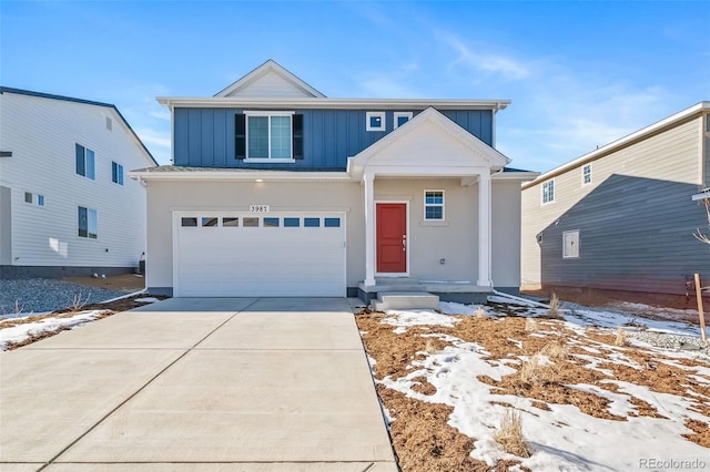 3899 N Shaenee St, Aurora, CO 80019 - view of front of house featuring board and batten siding, concrete driveway, a garage, and stucco siding