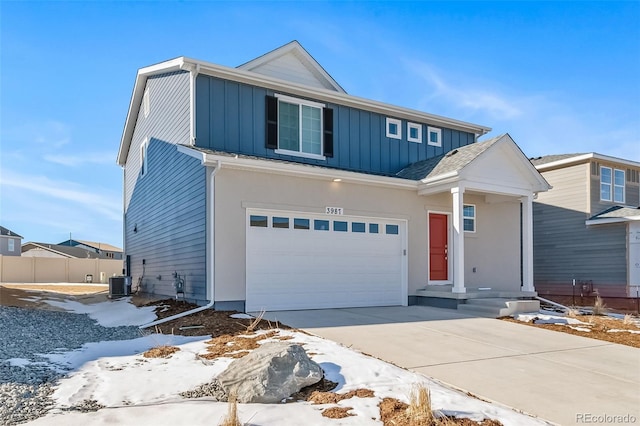 3899 N Shaenee St, Aurora, CO 80019 - view of front of house with board and batten siding, central AC unit, concrete driveway, and an attached garage