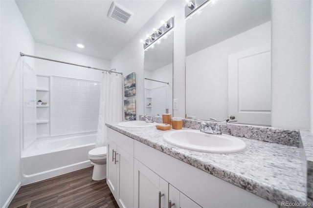 3899 N Shaenee St, Aurora, CO 80019 - full bathroom featuring wood finished floors, double vanity, toilet, and shower / bath combo