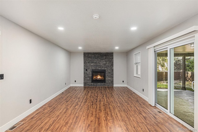 10051 E Walsh Pl, Denver, CO 80247 - unfurnished living room with wood finished floors, recessed lighting, and a fireplace
