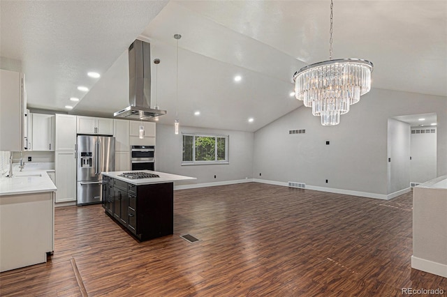 10051 E Walsh Pl, Denver, CO 80247 - kitchen with appliances with stainless steel finishes, exhaust hood, light countertops, open floor plan, and lofted ceiling