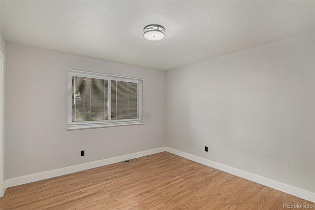 10051 E Walsh Pl, Denver, CO 80247 - unfurnished room featuring light wood-type flooring and a textured ceiling
