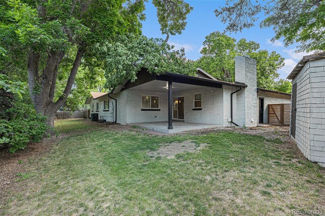 10051 E Walsh Pl, Denver, CO 80247 - rear view of property featuring a chimney and a patio