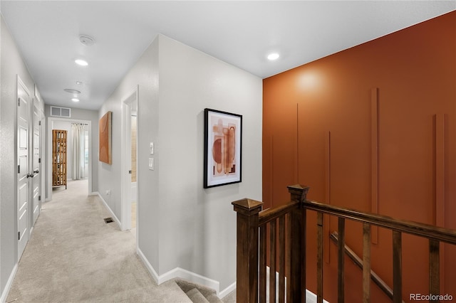 hall with visible vents, light carpet, baseboards, recessed lighting, and an upstairs landing