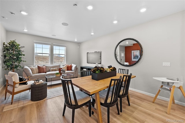 dining room featuring baseboards, recessed lighting, and light wood-style flooring