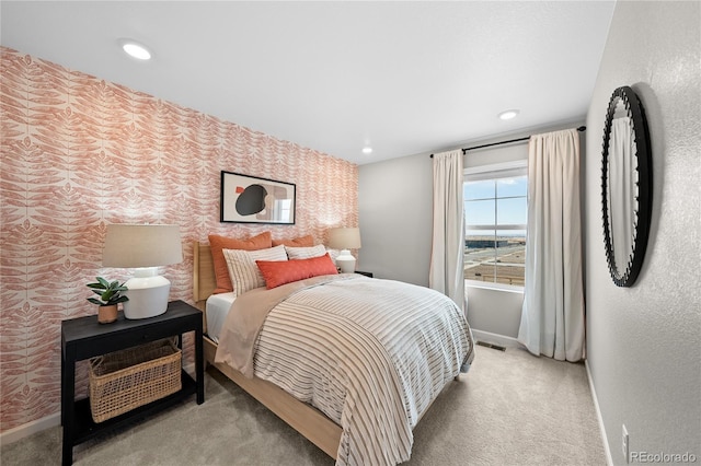 bedroom with carpet floors, baseboards, visible vents, and wallpapered walls