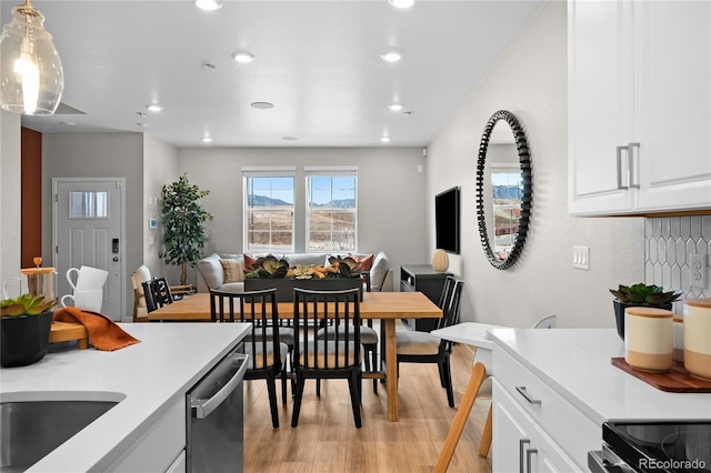 kitchen featuring light countertops, stainless steel appliances, recessed lighting, and light wood-style flooring
