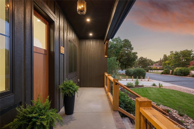 balcony at dusk with covered porch