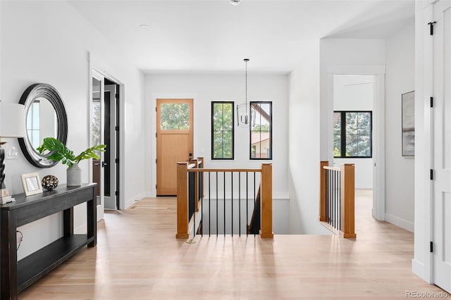 hallway with plenty of natural light and light hardwood / wood-style flooring