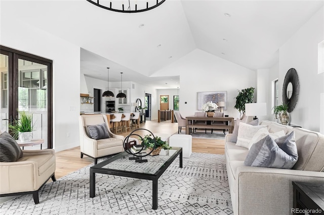 living room featuring light hardwood / wood-style flooring and vaulted ceiling