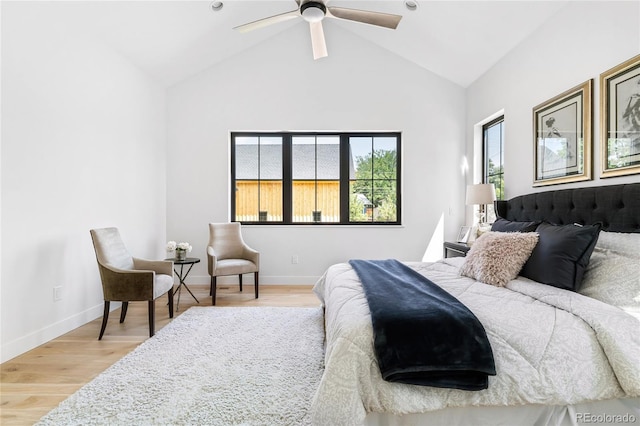 bedroom with ceiling fan, wood-type flooring, and vaulted ceiling