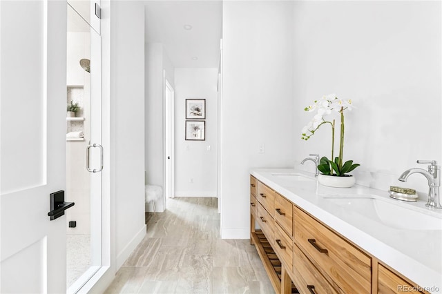 bathroom with walk in shower and vanity