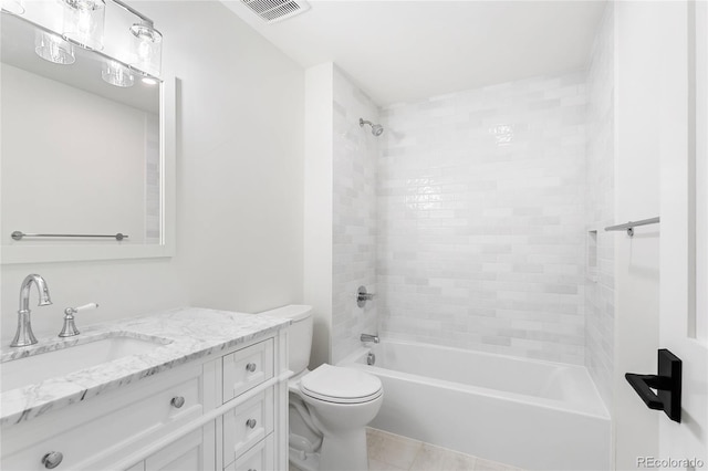 full bathroom featuring tiled shower / bath combo, toilet, tile patterned flooring, and vanity