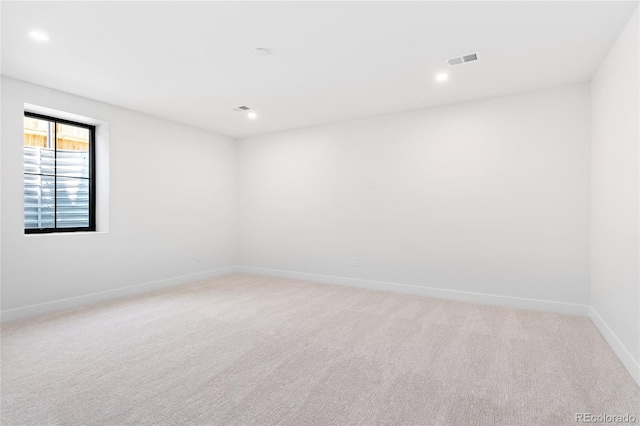 empty room featuring light carpet