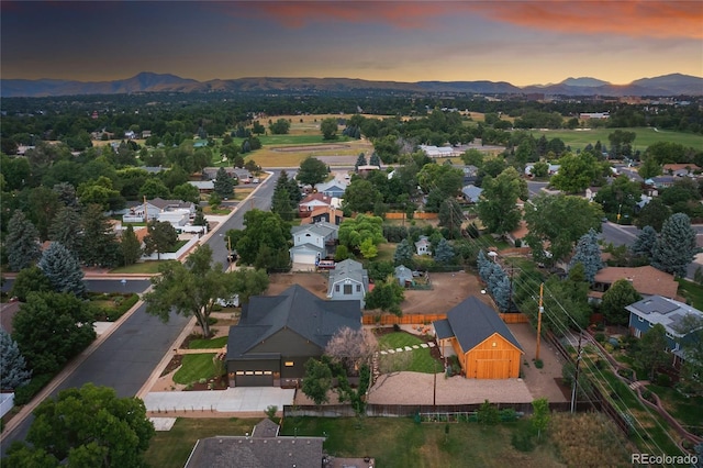 aerial view at dusk featuring a mountain view