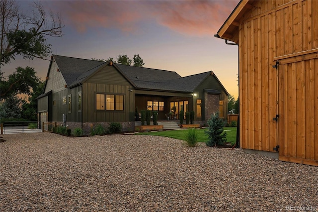 view of back house at dusk