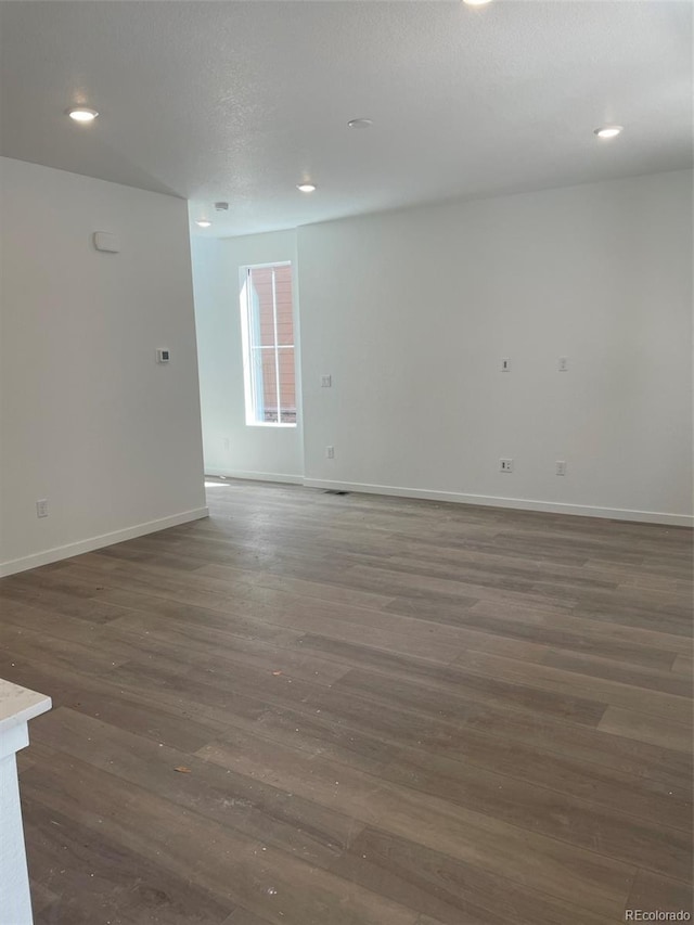 6750 Juniper Dr, Thornton, CO 80602 - unfurnished room featuring baseboards, dark wood-type flooring, and recessed lighting