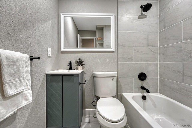 full bathroom with shower / bathtub combination, toilet, vanity, and a textured wall