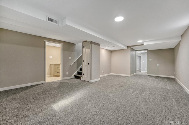 finished below grade area featuring visible vents, baseboards, stairs, carpet floors, and recessed lighting