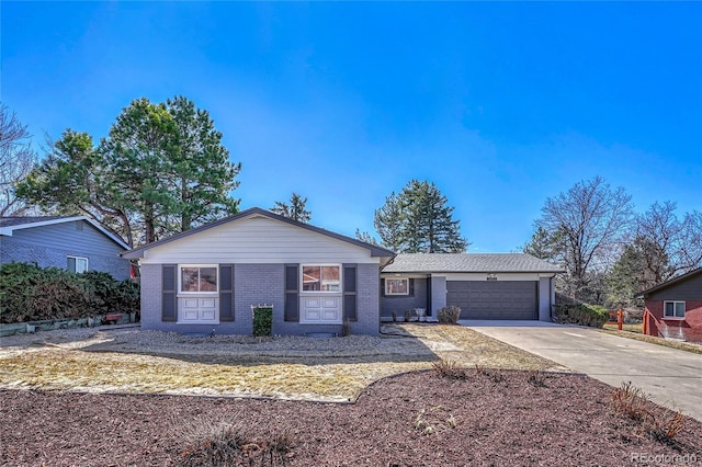 ranch-style house featuring brick siding, concrete driveway, and an attached garage