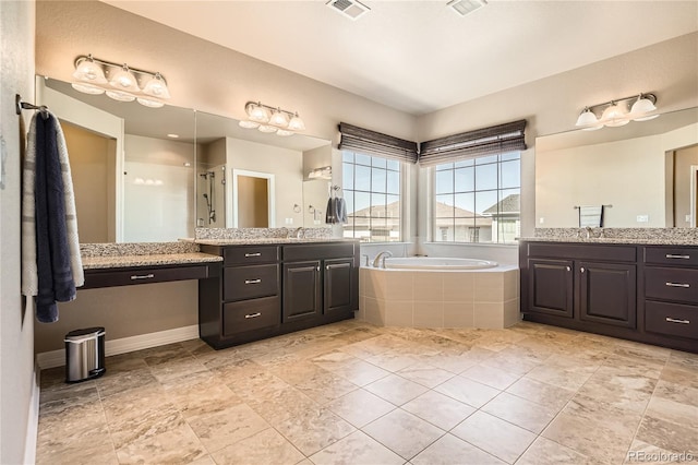 bathroom with visible vents, two vanities, a shower stall, and a bath