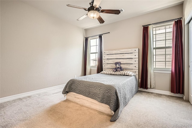 bedroom with carpet floors, baseboards, and a ceiling fan