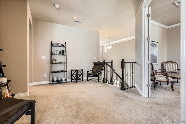 living area featuring carpet flooring, visible vents, an upstairs landing, baseboards, and ornamental molding