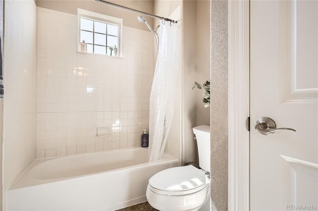 bathroom featuring toilet and shower / bath combo