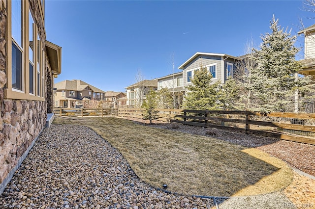 view of yard featuring a residential view and fence