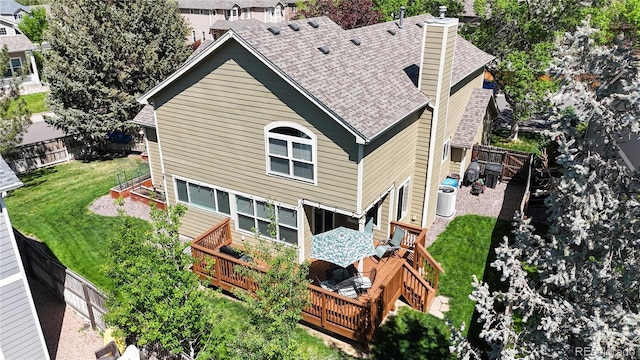 back of house with a shingled roof, a deck, a chimney, and central air condition unit
