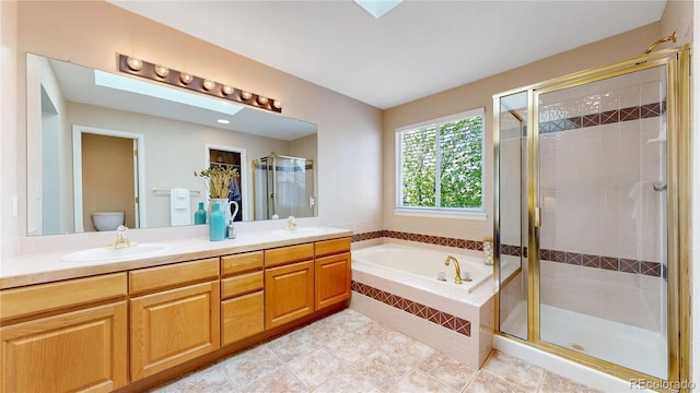 bathroom featuring a shower stall, a bath, double vanity, toilet, and tile patterned flooring