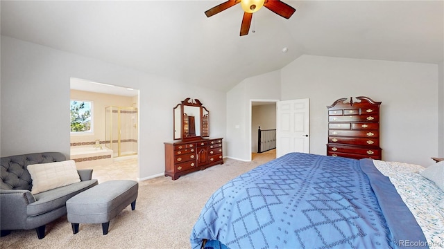 bedroom featuring light carpet, lofted ceiling, ceiling fan, ensuite bath, and baseboards