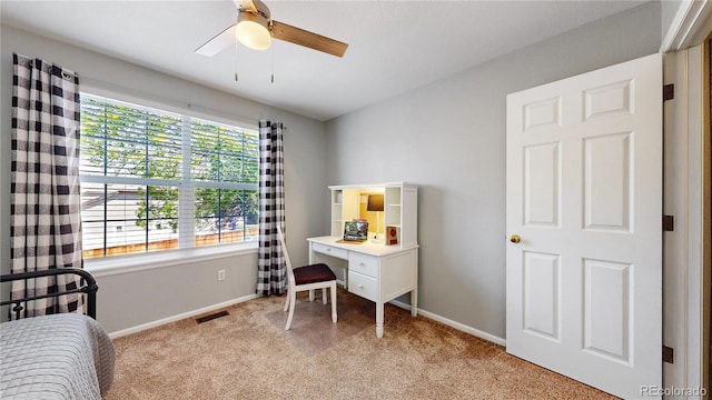 bedroom with light colored carpet, baseboards, and ceiling fan