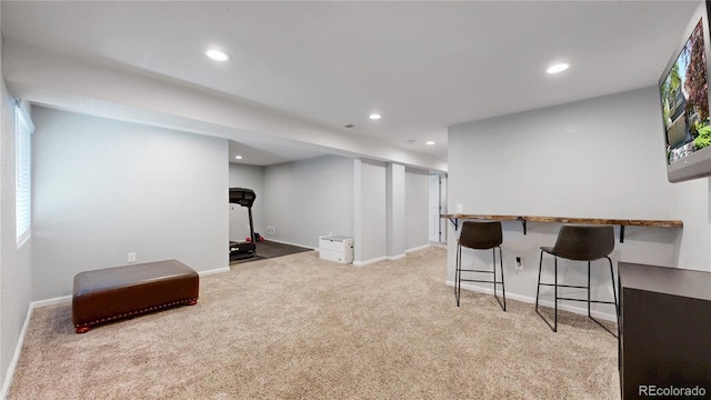recreation room with carpet flooring, recessed lighting, baseboards, and bar area