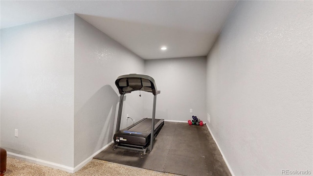 exercise area featuring baseboards and recessed lighting