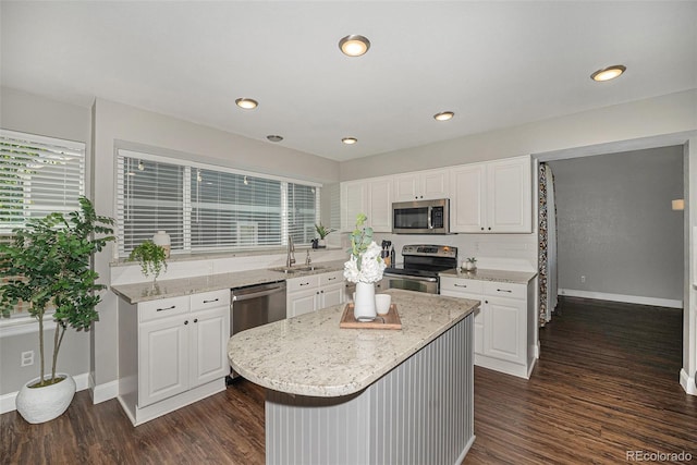 2980 E 135th Dr, Thornton, CO 80241 - kitchen featuring stainless steel appliances, dark wood finished floors, white cabinetry, and recessed lighting